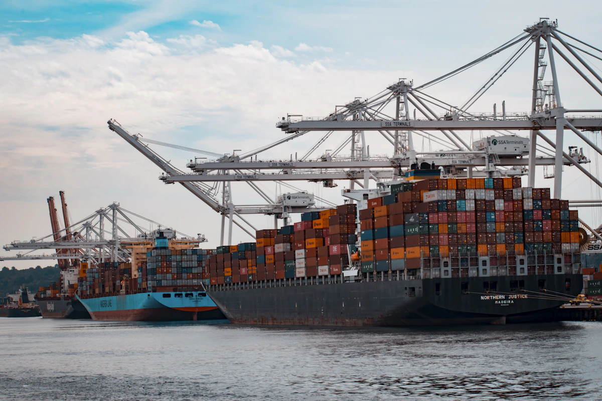 Container ship moving international cargo through a busy seaport
